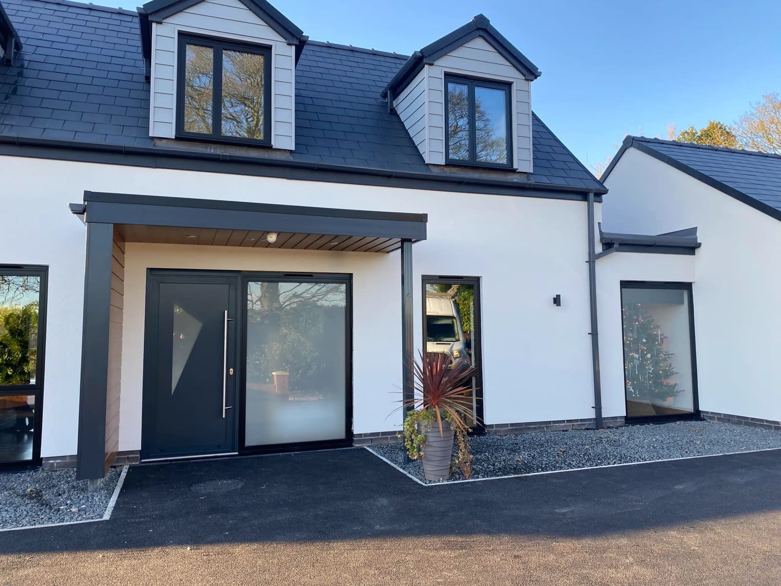 Anthracite windows and composite front door on a white rendered house
